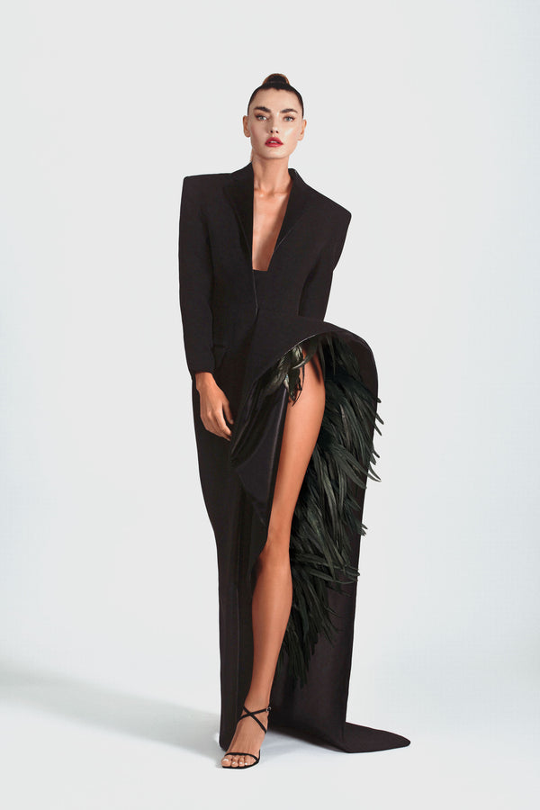 Slashed, tailored jacket-dress in black silk crêpe with latex lapels and a deconstructed side seam ruffle embellished with natural iridescent plumage 